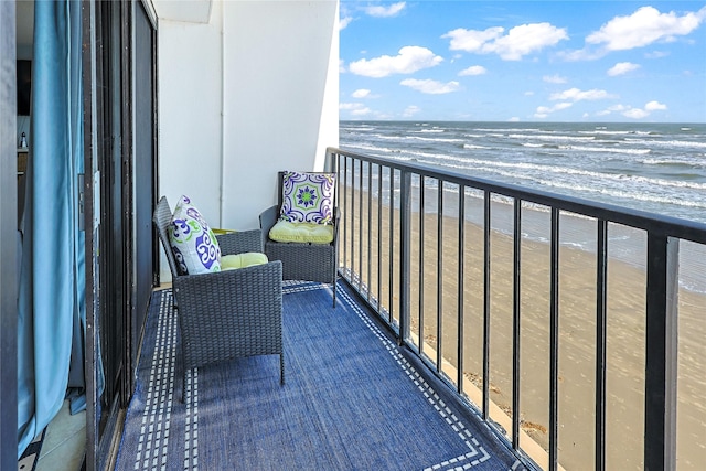 balcony with a beach view and a water view