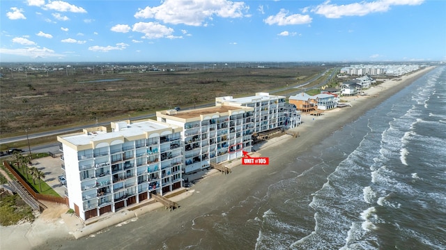 drone / aerial view with a beach view and a water view