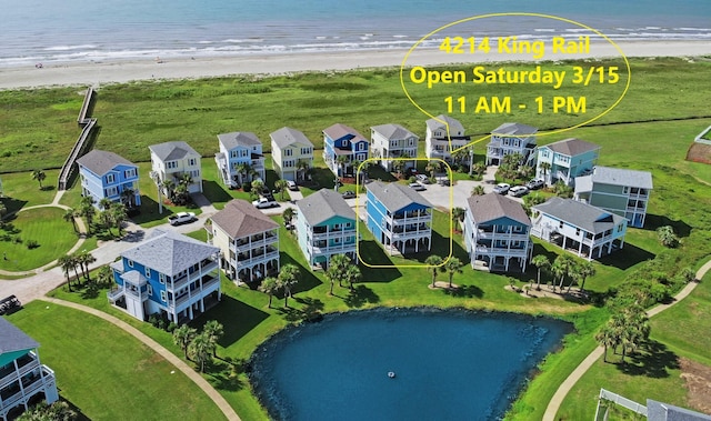 aerial view with a beach view, a residential view, and a water view