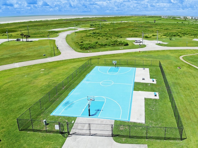 view of basketball court with community basketball court, a yard, and fence