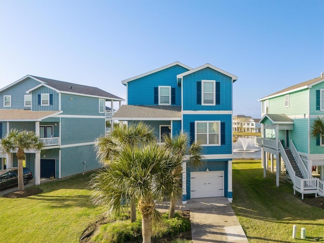 coastal inspired home with an attached garage, board and batten siding, concrete driveway, and a front yard