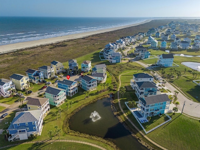 bird's eye view featuring a view of the beach, a water view, and a residential view