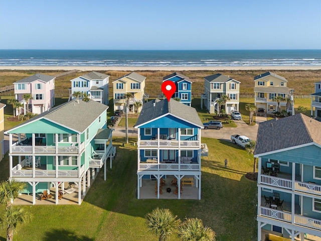 bird's eye view with a residential view, a water view, and a beach view