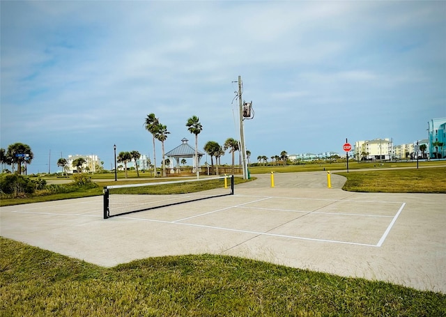 surrounding community featuring a gazebo, a lawn, and community basketball court