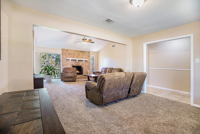 carpeted living area with baseboards, visible vents, ceiling fan, vaulted ceiling, and a brick fireplace