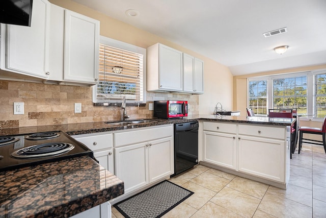 kitchen with visible vents, a peninsula, a sink, white cabinets, and dishwasher