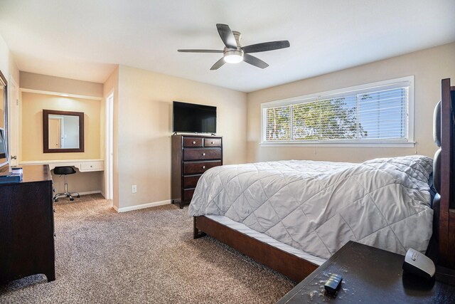 bedroom featuring ceiling fan, baseboards, and carpet