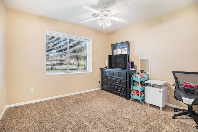 office space featuring baseboards, carpet floors, and a ceiling fan