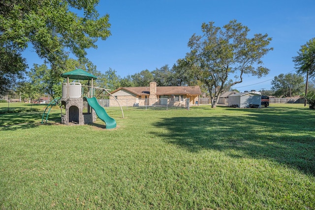 community playground with a lawn and fence