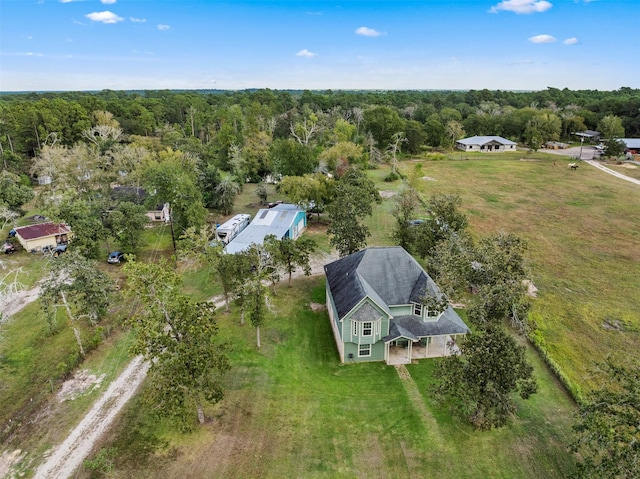 birds eye view of property with a forest view