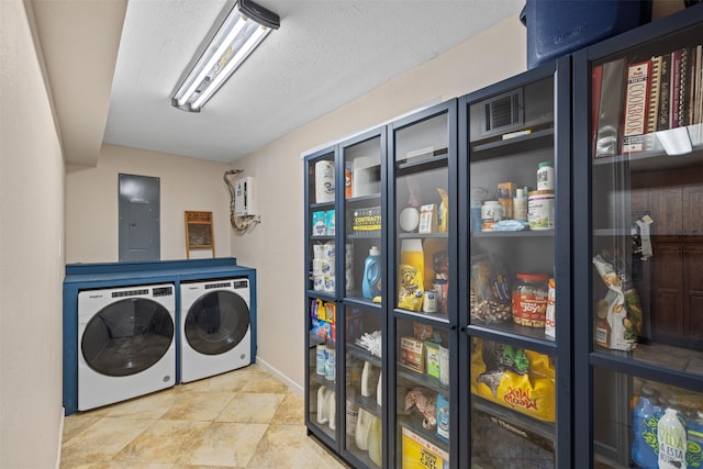 washroom with electric panel, laundry area, independent washer and dryer, and a textured ceiling