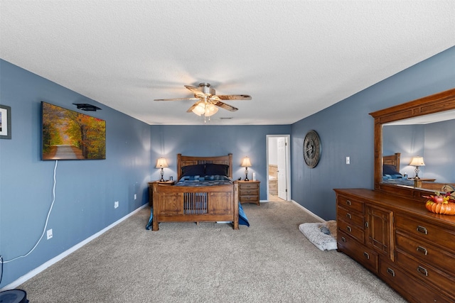 carpeted bedroom with ceiling fan, a textured ceiling, and baseboards