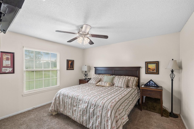 bedroom with a ceiling fan, carpet, baseboards, and a textured ceiling