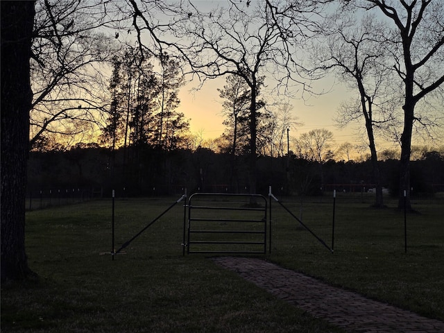 gate at dusk with a yard