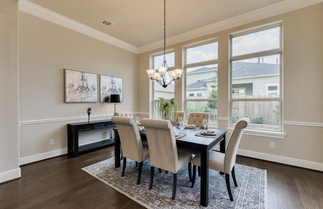 dining space with baseboards, visible vents, dark wood finished floors, an inviting chandelier, and crown molding