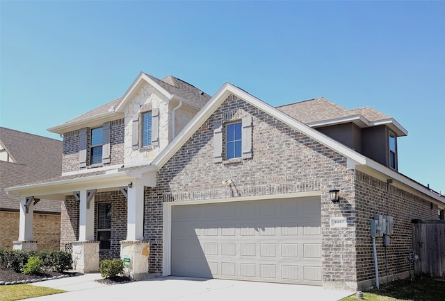 view of front of house featuring concrete driveway, an attached garage, and brick siding