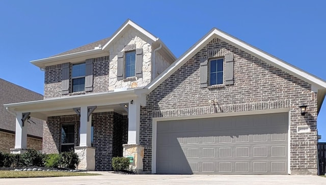 view of front facade featuring concrete driveway, an attached garage, and brick siding