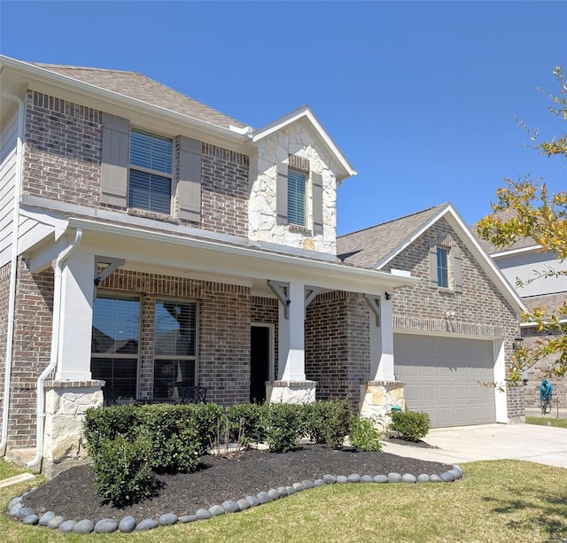 traditional home featuring a garage, brick siding, covered porch, and driveway