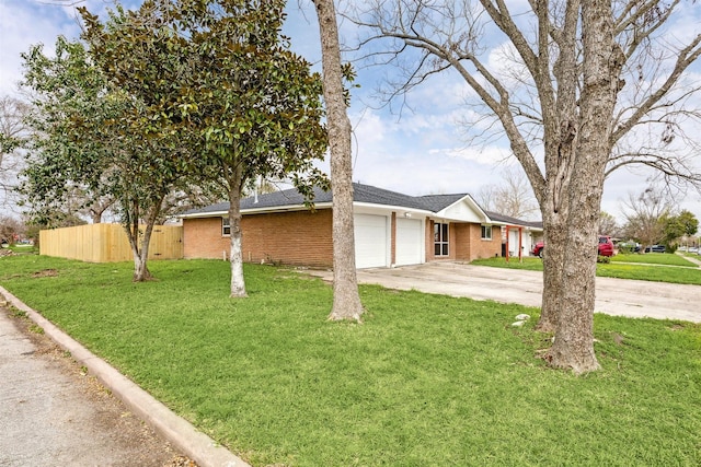 view of front of house with a front lawn, a garage, fence, and brick siding