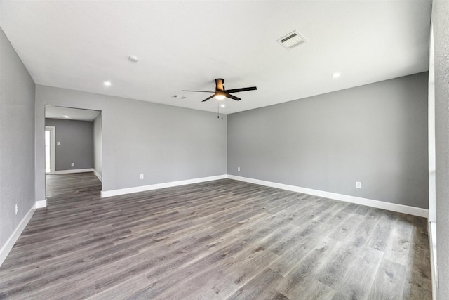 empty room featuring visible vents, baseboards, recessed lighting, wood finished floors, and a ceiling fan