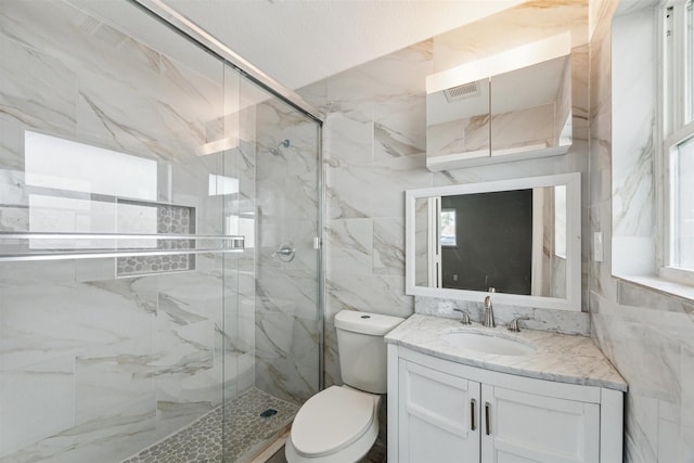 full bath with vanity, toilet, visible vents, and a marble finish shower