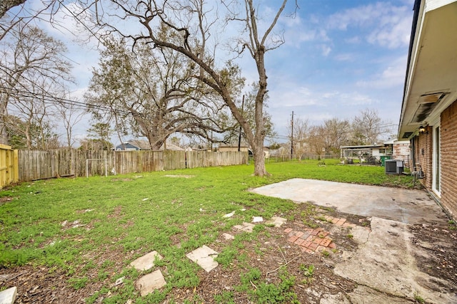 view of yard featuring a patio, central AC unit, and a fenced backyard