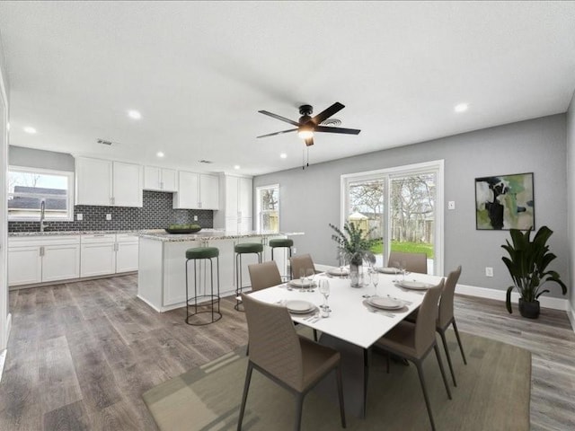 dining area with a ceiling fan, recessed lighting, wood finished floors, and baseboards