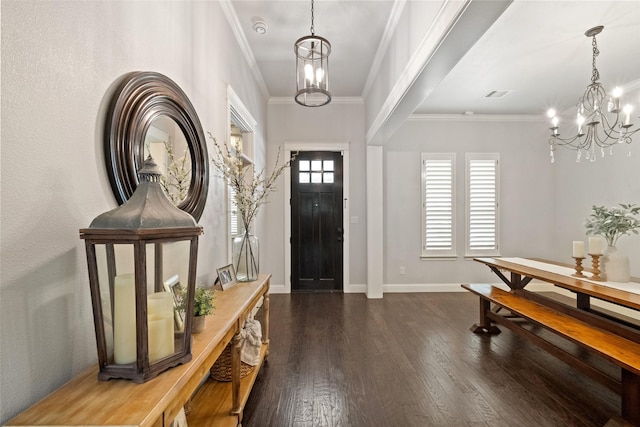 entrance foyer featuring hardwood / wood-style floors, baseboards, visible vents, crown molding, and a notable chandelier