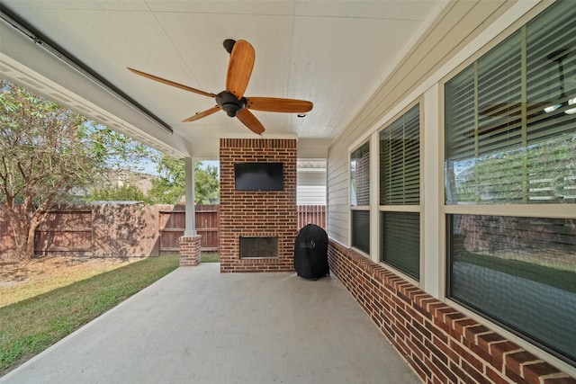 view of patio / terrace featuring fence, an outdoor brick fireplace, and ceiling fan