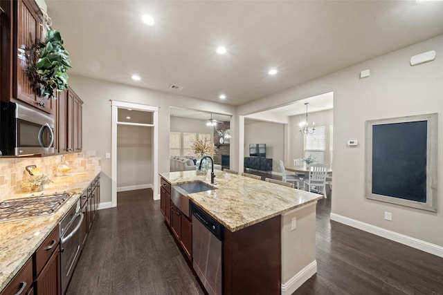 kitchen with backsplash, stainless steel appliances, dark wood-type flooring, and a sink