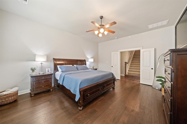 bedroom featuring visible vents, baseboards, dark wood-type flooring, and a ceiling fan