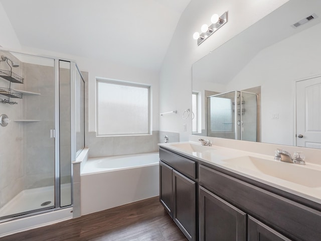 full bathroom with a shower stall, vaulted ceiling, visible vents, and a sink