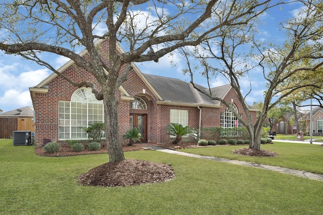 7419 Place Vendome, Spring, TX 77379 - view of front of home with brick siding, central AC unit, french doors, and roof with shingles