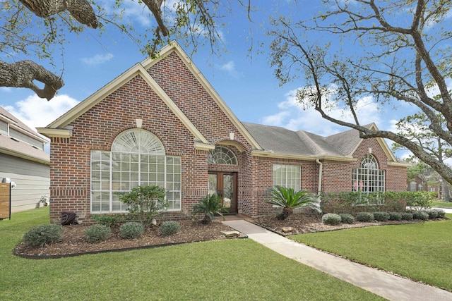 7419 Place Vendome, Spring, TX 77379 - view of front facade with brick siding, a front lawn, and roof with shingles