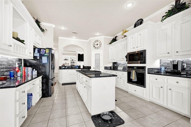7419 Place Vendome, Spring, TX 77379 - kitchen with wall oven, built in microwave, decorative backsplash, dark countertops, and a center island
