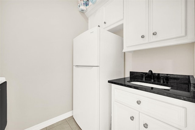 7419 Place Vendome, Spring, TX 77379 - kitchen with a sink, freestanding refrigerator, white cabinetry, and light tile patterned flooring