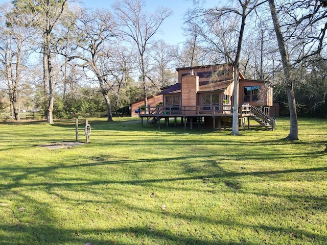 view of yard with a wooden deck and stairs