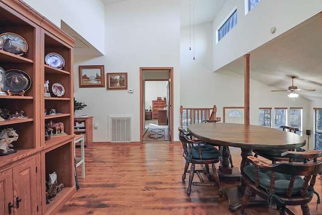 dining area featuring visible vents, a healthy amount of sunlight, a ceiling fan, and wood finished floors