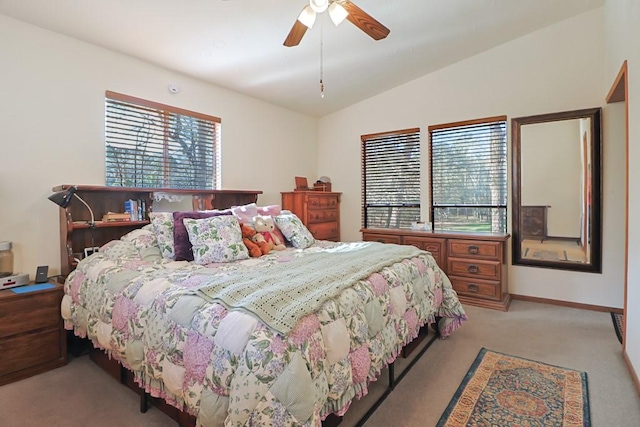 bedroom with light carpet, baseboards, a ceiling fan, and lofted ceiling