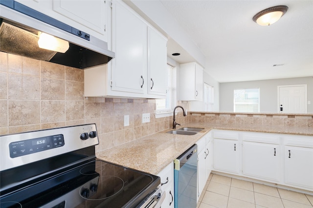 kitchen with under cabinet range hood, a sink, stainless steel appliances, light tile patterned flooring, and decorative backsplash