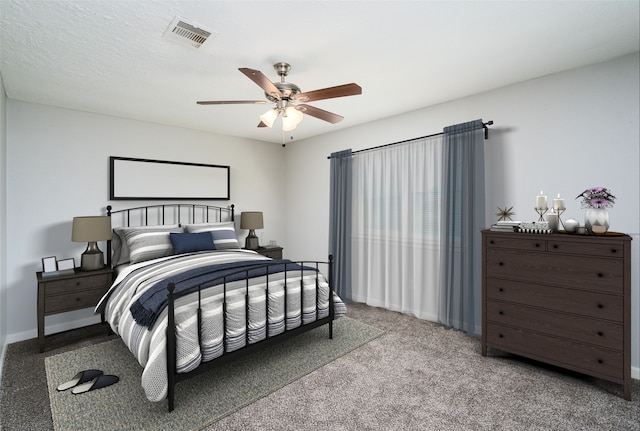 carpeted bedroom featuring visible vents, baseboards, and ceiling fan