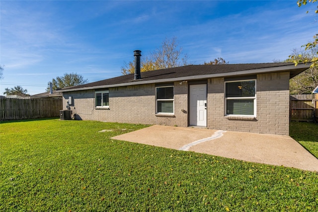 back of house featuring a patio, central AC unit, a lawn, and a fenced backyard