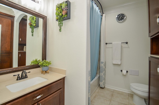 bathroom featuring tile patterned flooring, baseboards, toilet, shower / tub combo with curtain, and vanity