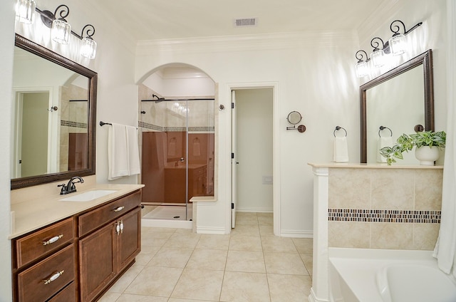 bathroom featuring visible vents, a shower stall, crown molding, a bath, and tile patterned flooring