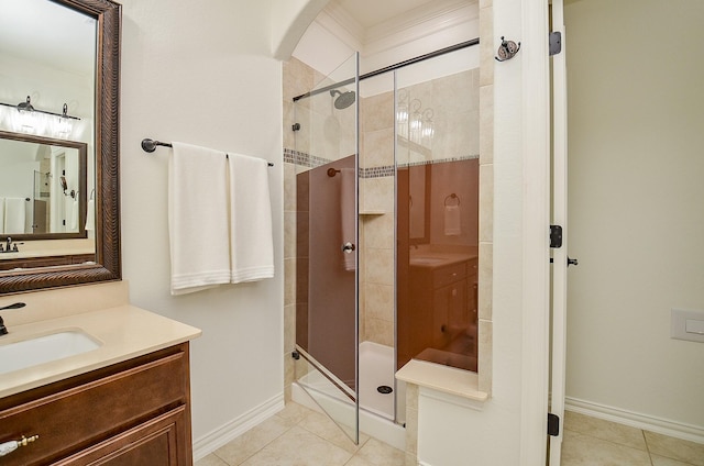 full bath with vanity, a shower stall, baseboards, and tile patterned floors