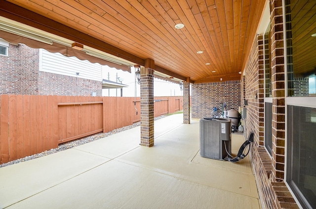 view of patio / terrace with cooling unit and fence