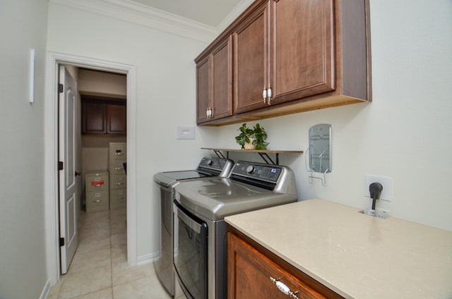 washroom with light tile patterned floors, baseboards, cabinet space, separate washer and dryer, and crown molding