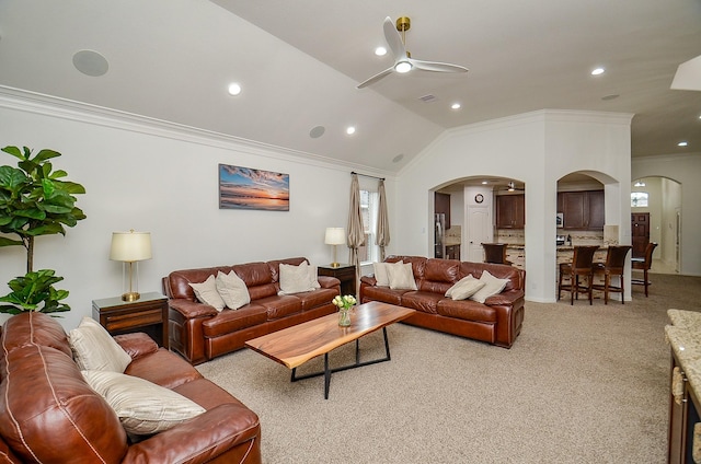 living room with ceiling fan, crown molding, arched walkways, and light carpet