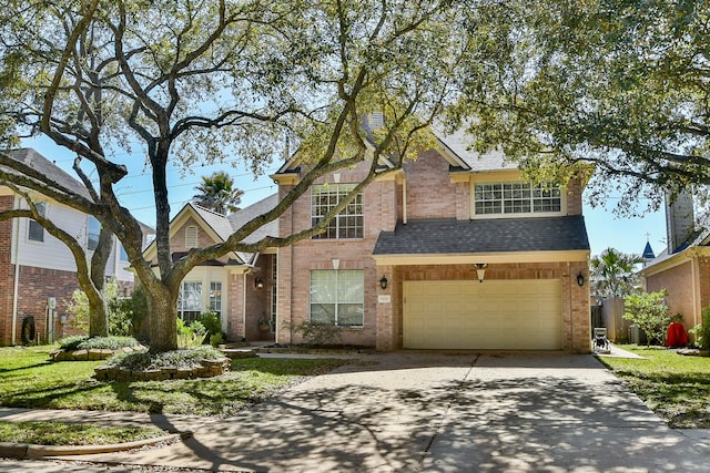 traditional-style house featuring roof with shingles, an attached garage, concrete driveway, and brick siding