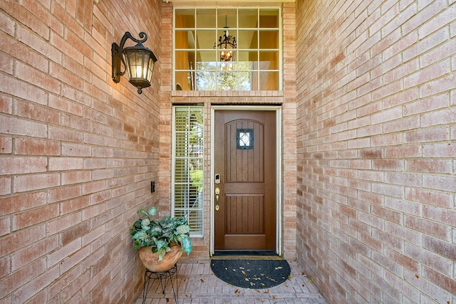doorway to property with brick siding